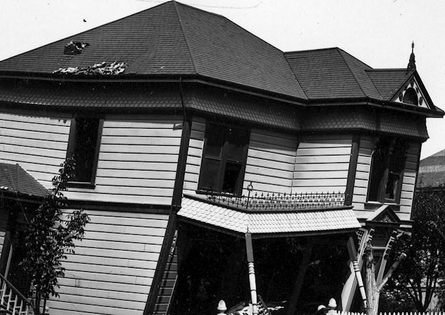 black and white photo of a collapsing house