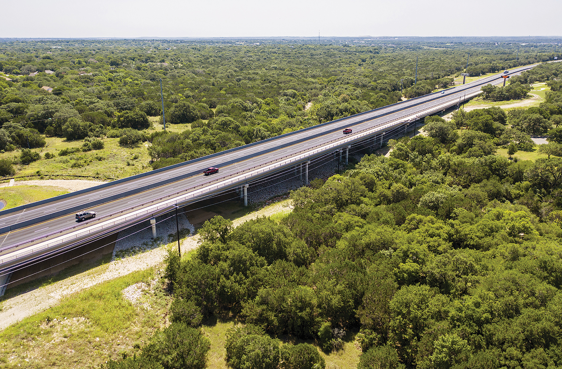 multi lane highway surrounded by trees