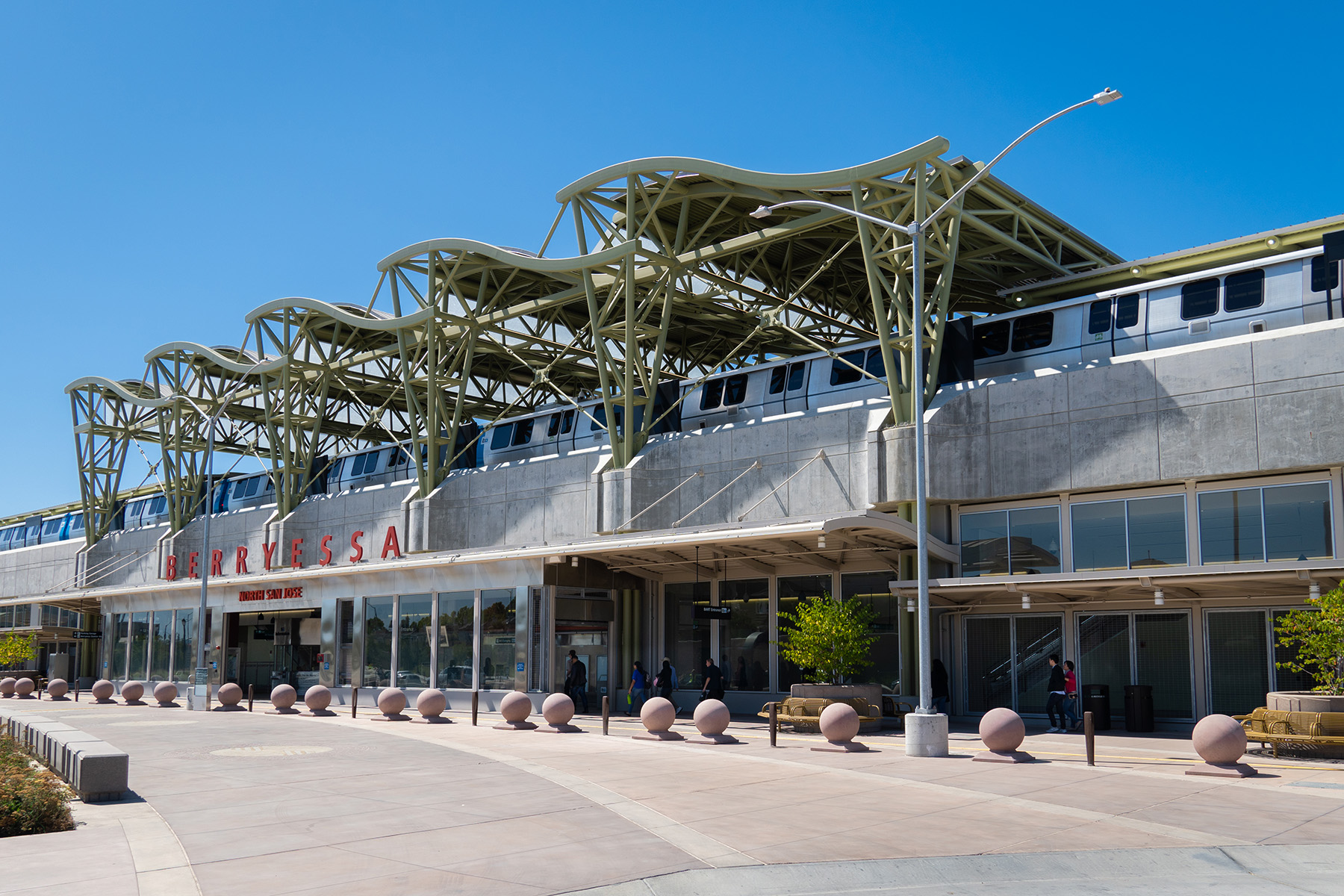 outdoor transit station showing a train on the platform