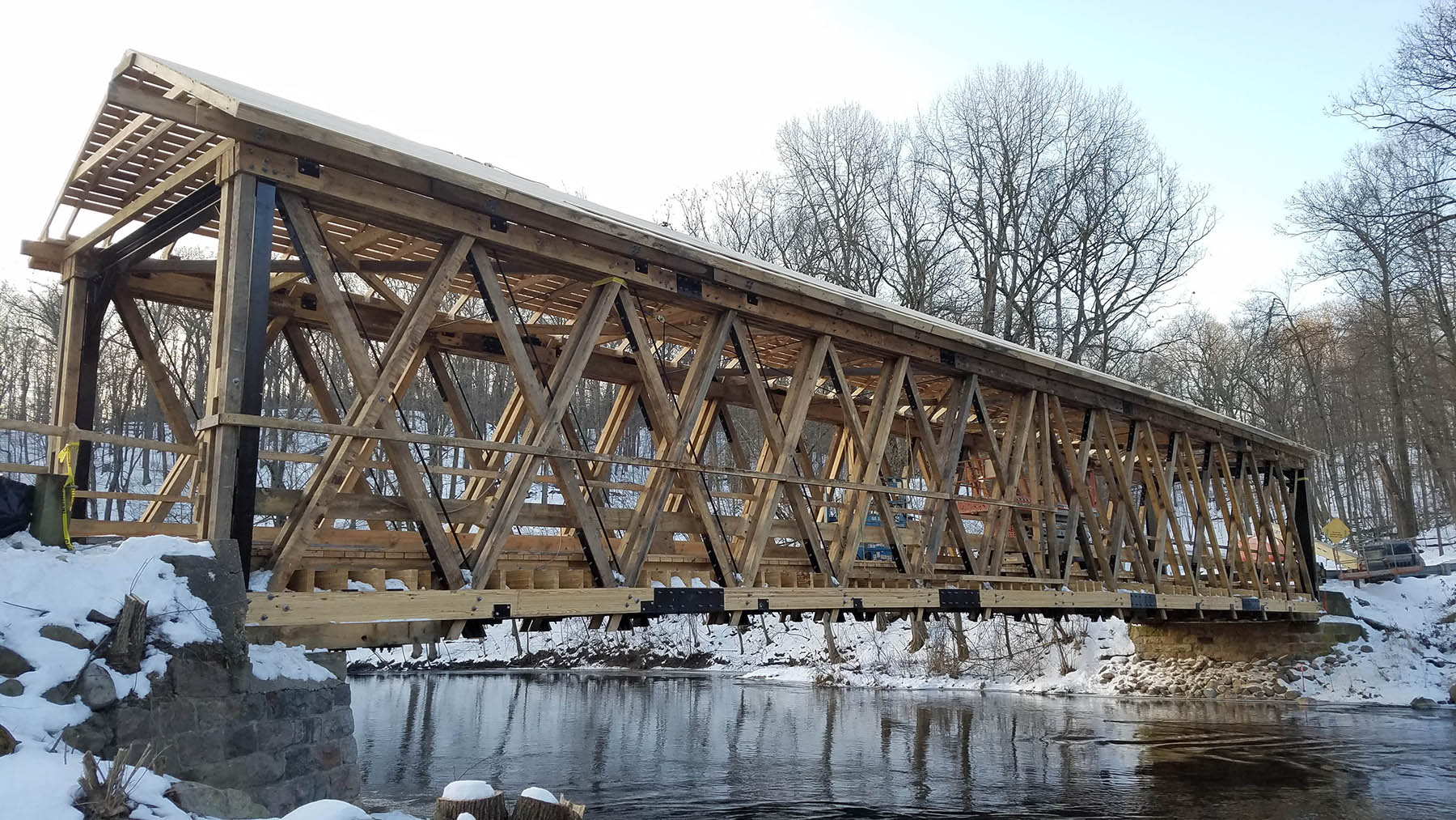 in construction photo of a one lane wooden bridge