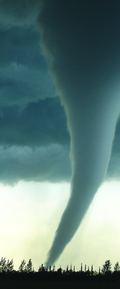 grey clouds above white tornado touched down in a field