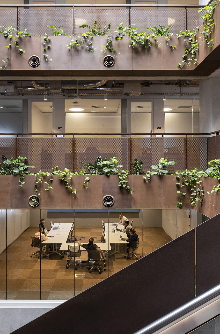 A multistory atrium with plantings on each floor