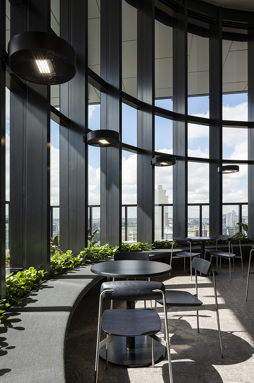 A multistory enclosed sky garden is shown. There is a seating area. 