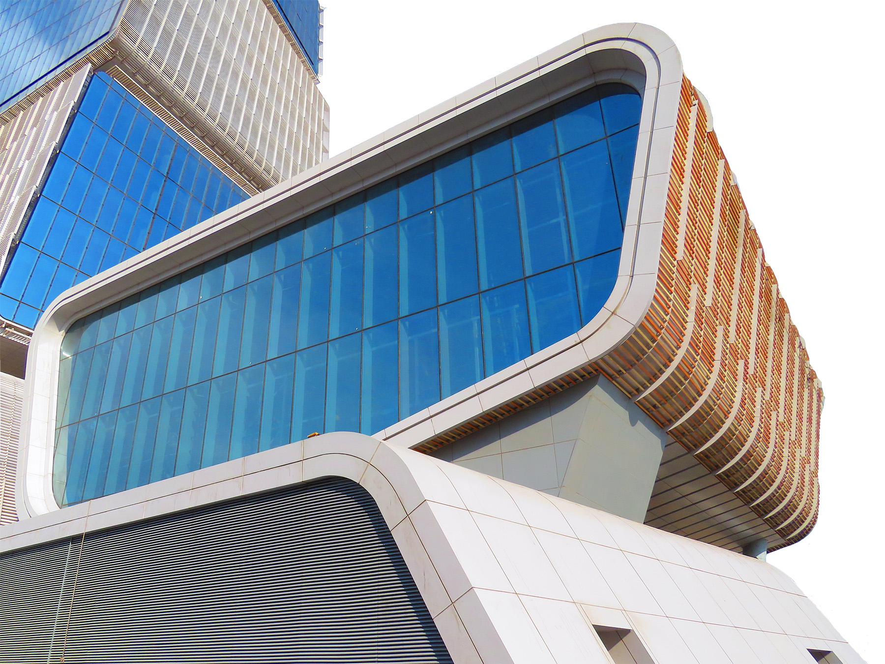 Image shows part of an auditorium with multistory glass windows. 