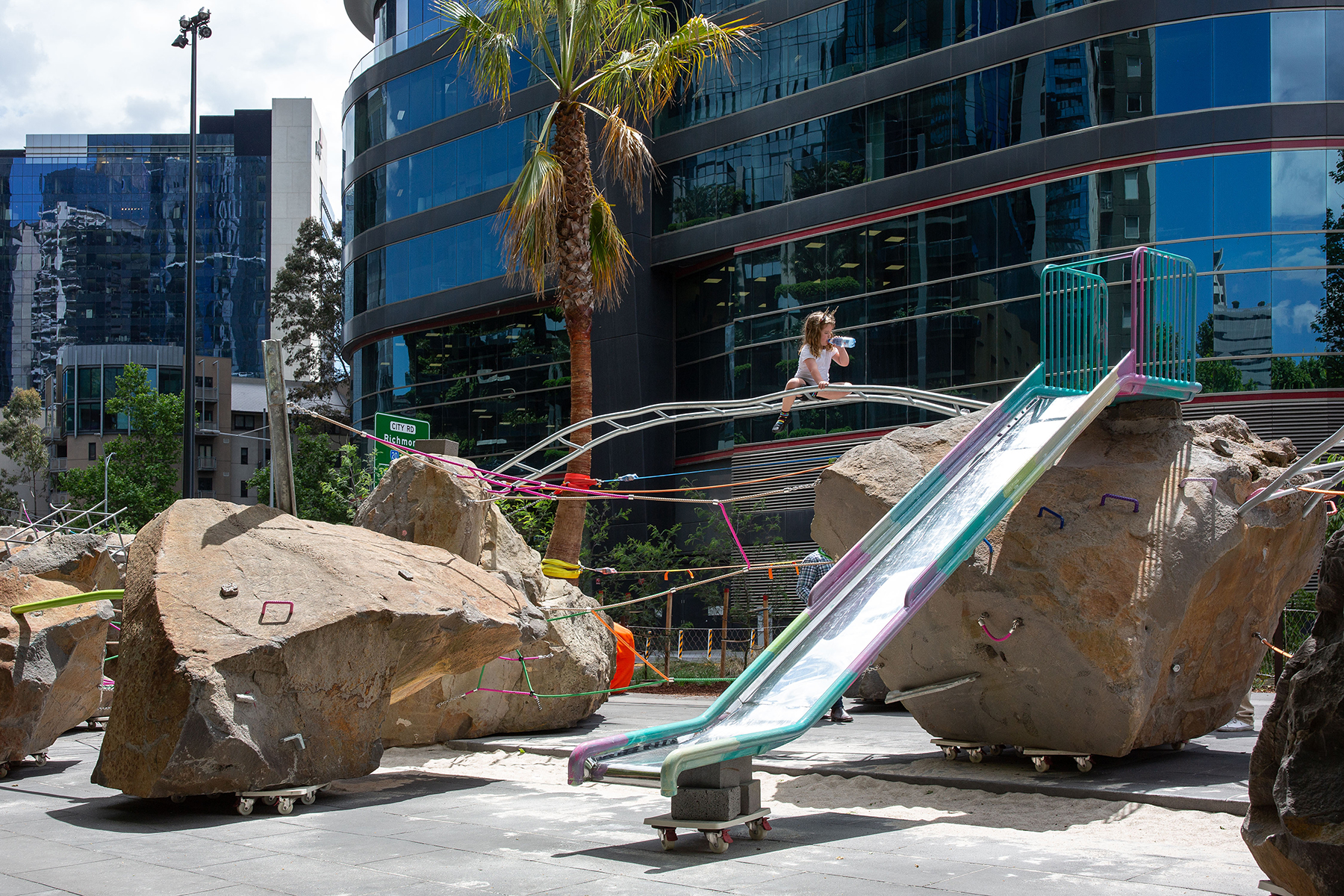 Rocks on Wheels is a new playground in Melbourne, Australia, that is most notable for its use of boulders that are situated on what appear to be regular furniture dollies. (Image courtesy of Mike Hewson)