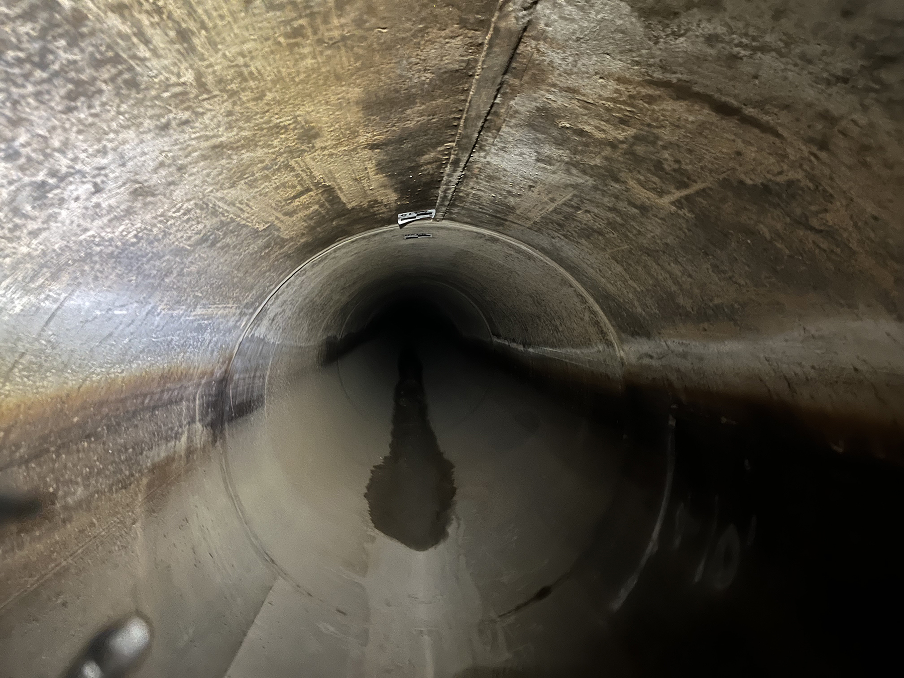 The section of the Red Mountain Tunnel undergoing rehabilitation, following power washing but before application of the GeoSpray 61 geopolymer mortar product. (Image courtesy of Michels Trenchless Inc.)