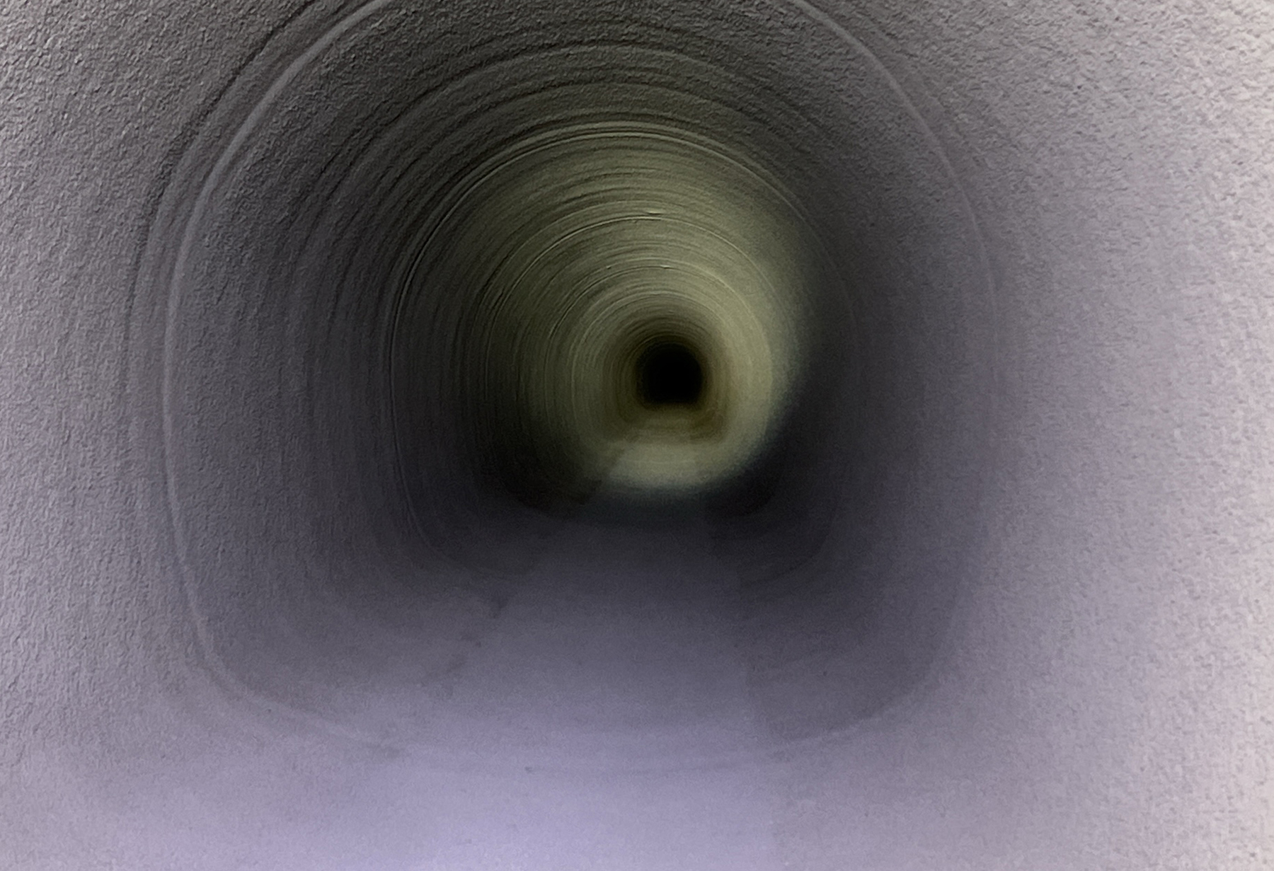 The section of the Red Mountain Tunnel undergoing rehabilitation following the application of the first sprayed-on layer of the GeoSpray 61 geopolymer mortar product. (Image courtesy of Michels Trenchless Inc.) 