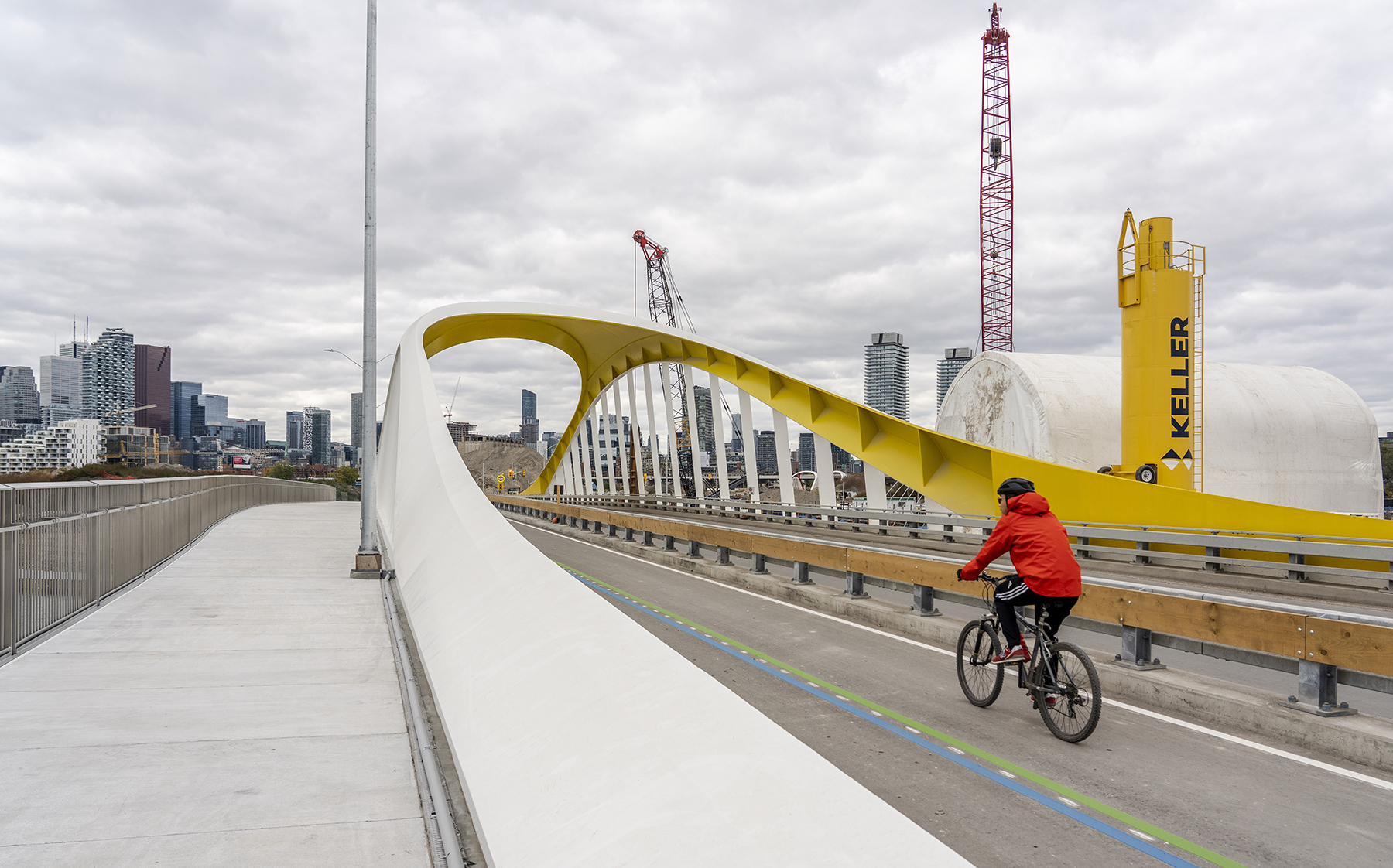 cyclist rides over bridge