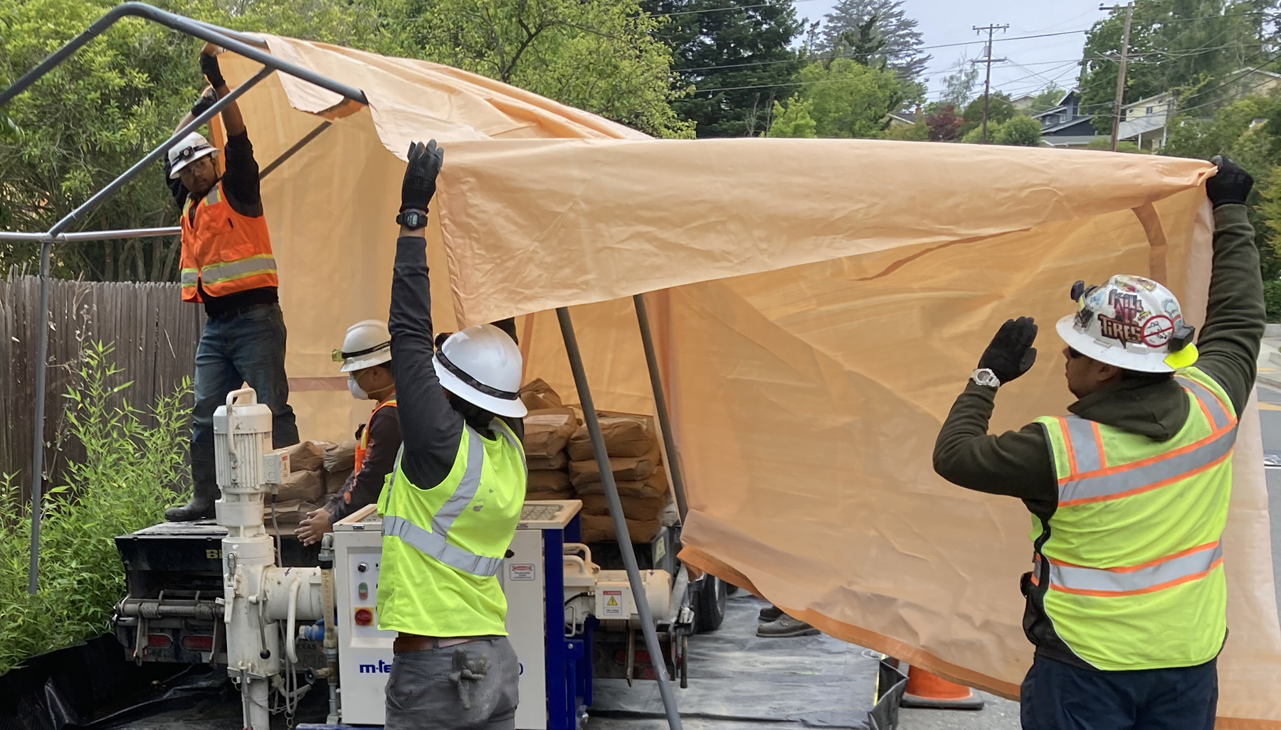 workers place tarps