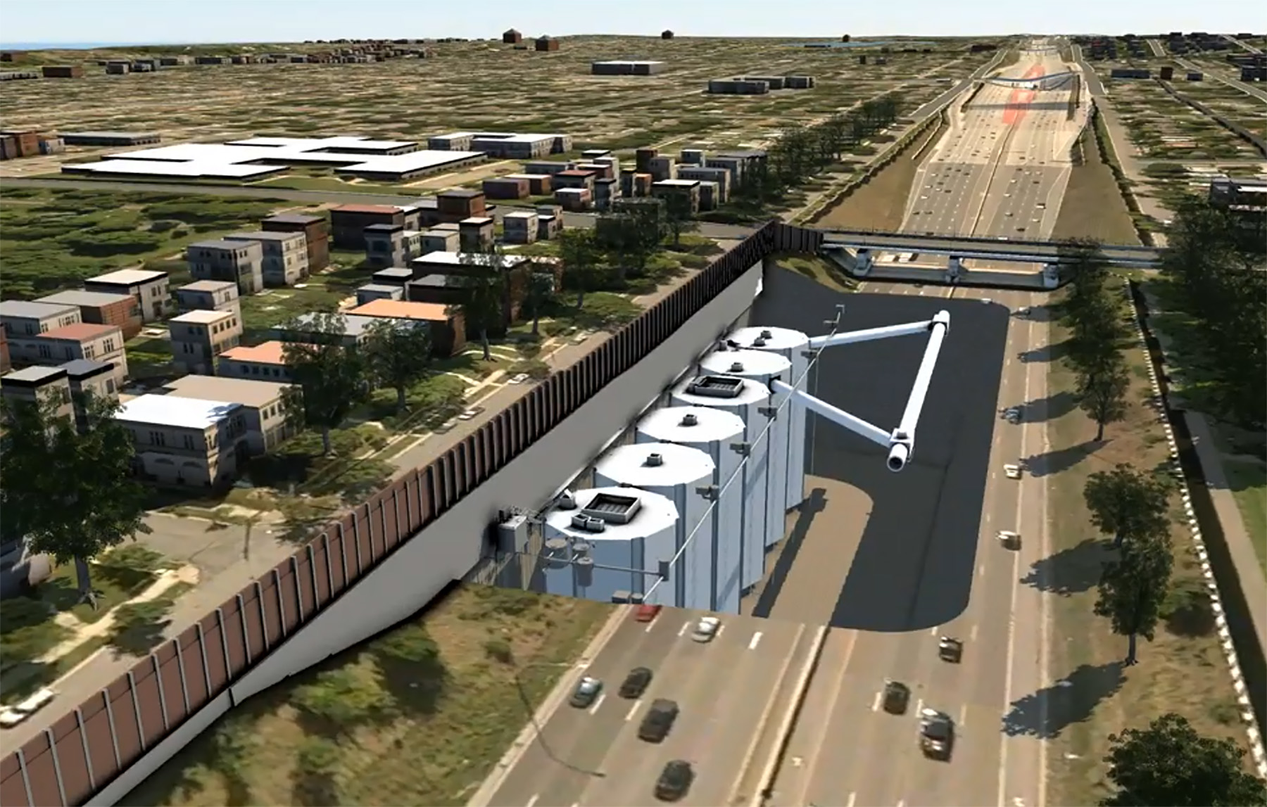 Photo shows an underground stormwater storage facility comprised of six interconnecting cells. The facility sits below the shoulder of a highway.  