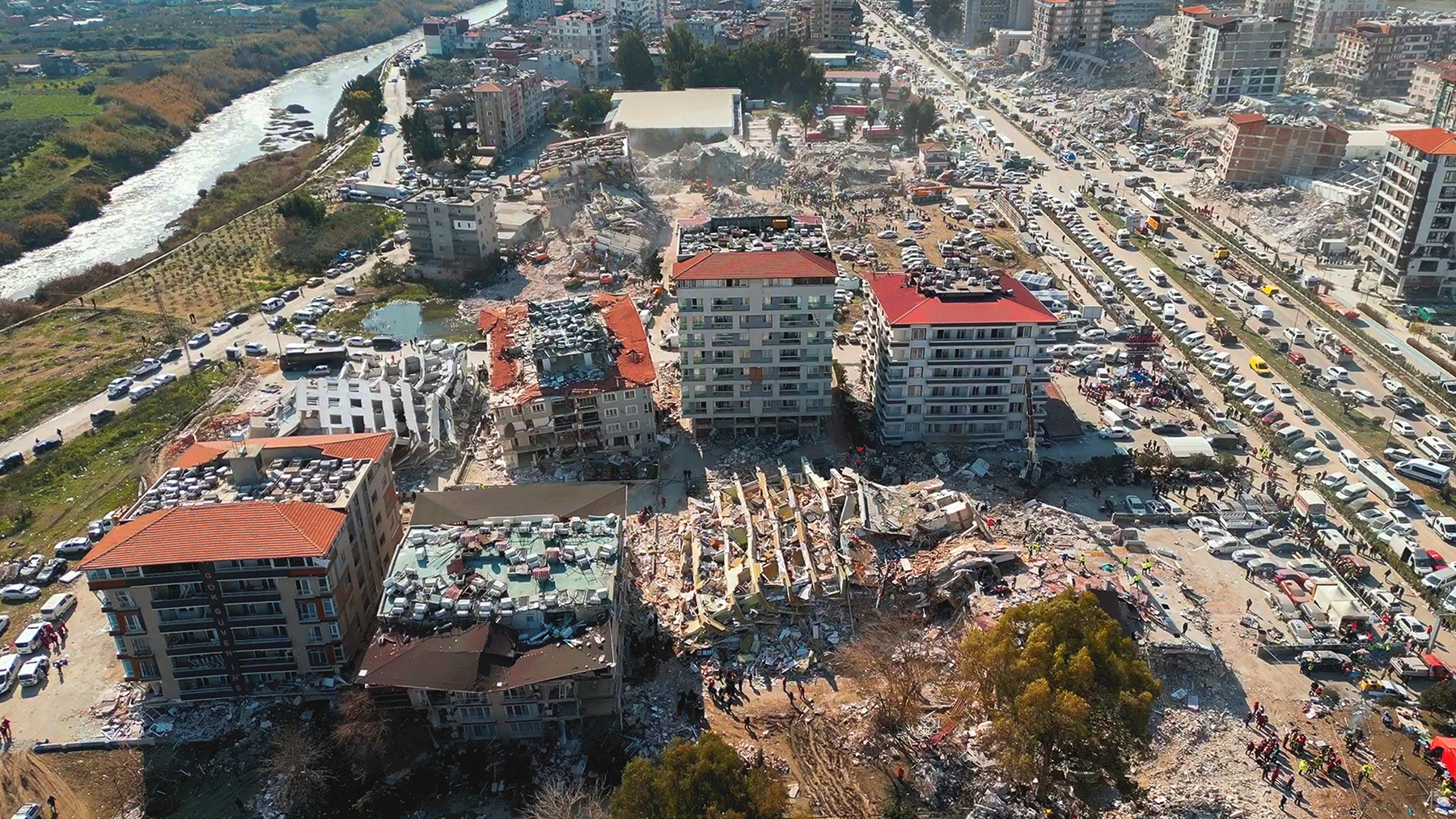 Image shows the aftermath of an earthquake with collapsed and partially collapsed structures. 