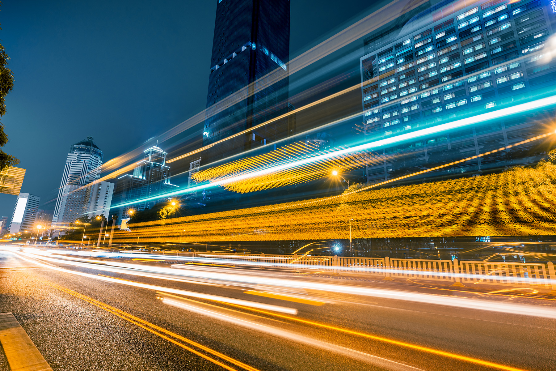 The image shows bright lights zooming along a highway. 