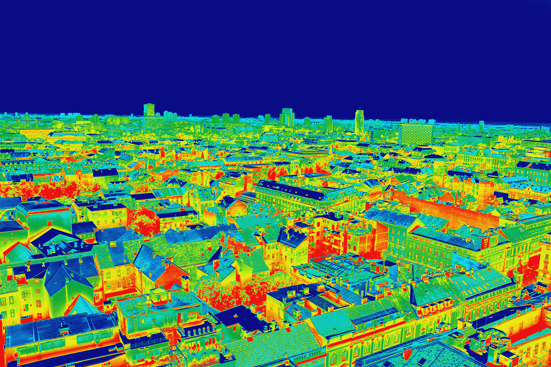 Image shows a cityscape that has been colored to reflect different temperatures. Red/orange is the warmest and blue is the coolest. 