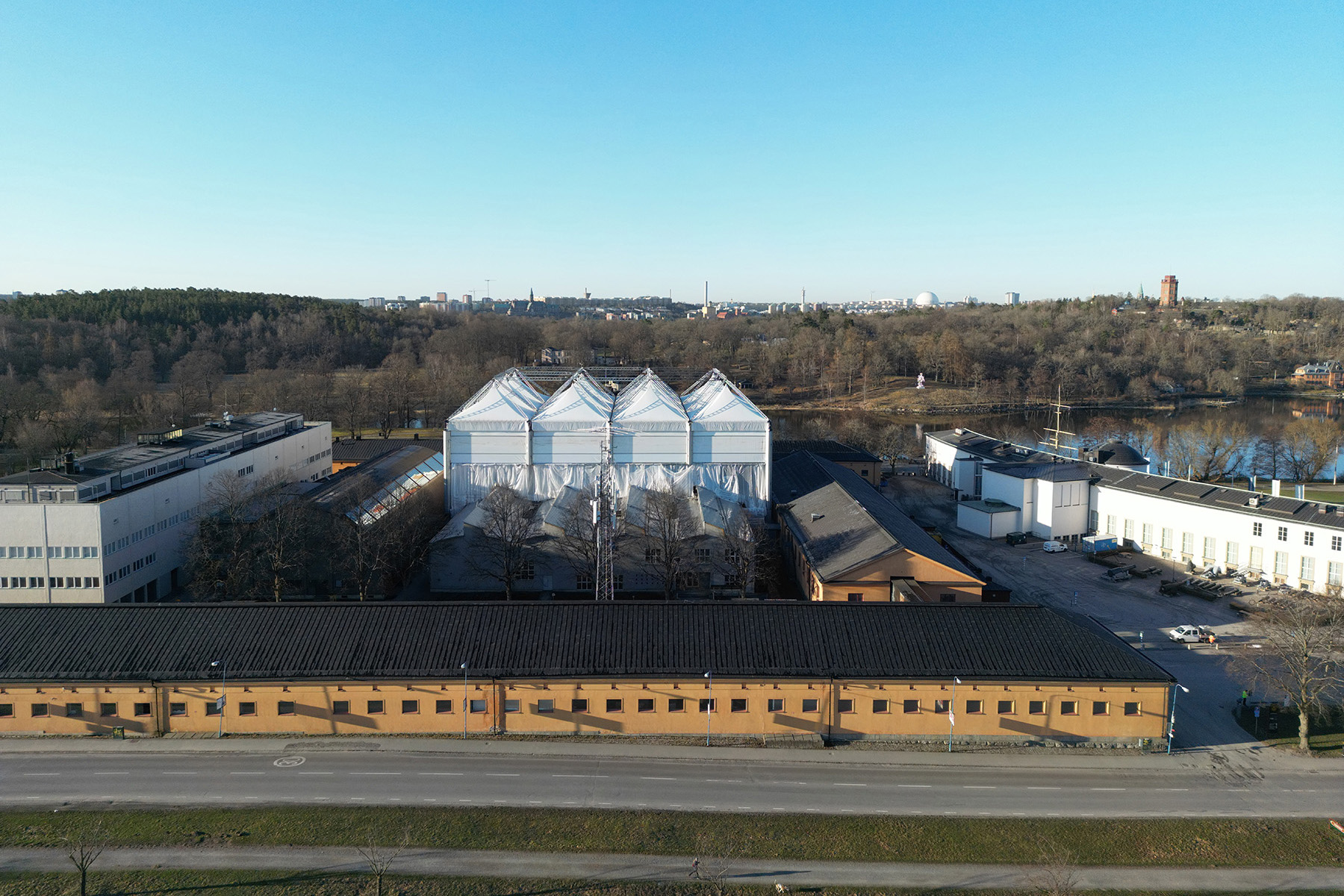 A giant white tent with multiple peaks covered the worksite to protect the wooden elements during construction. 