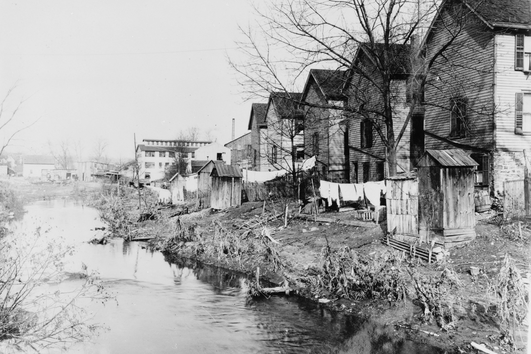 Photograph shows waterfront, run-down housing developments. 