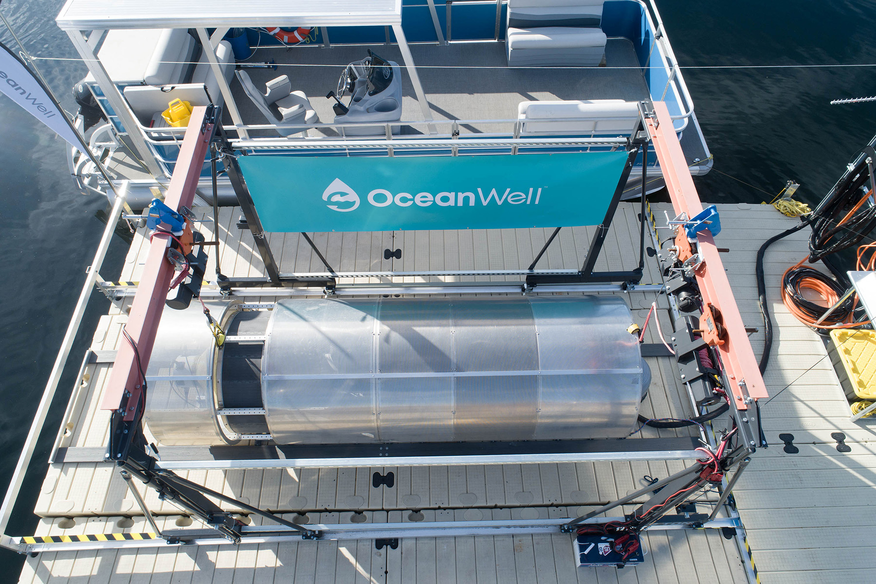 The photo shows one cylindrical desalination container on the deck of a boat floating in the ocean.