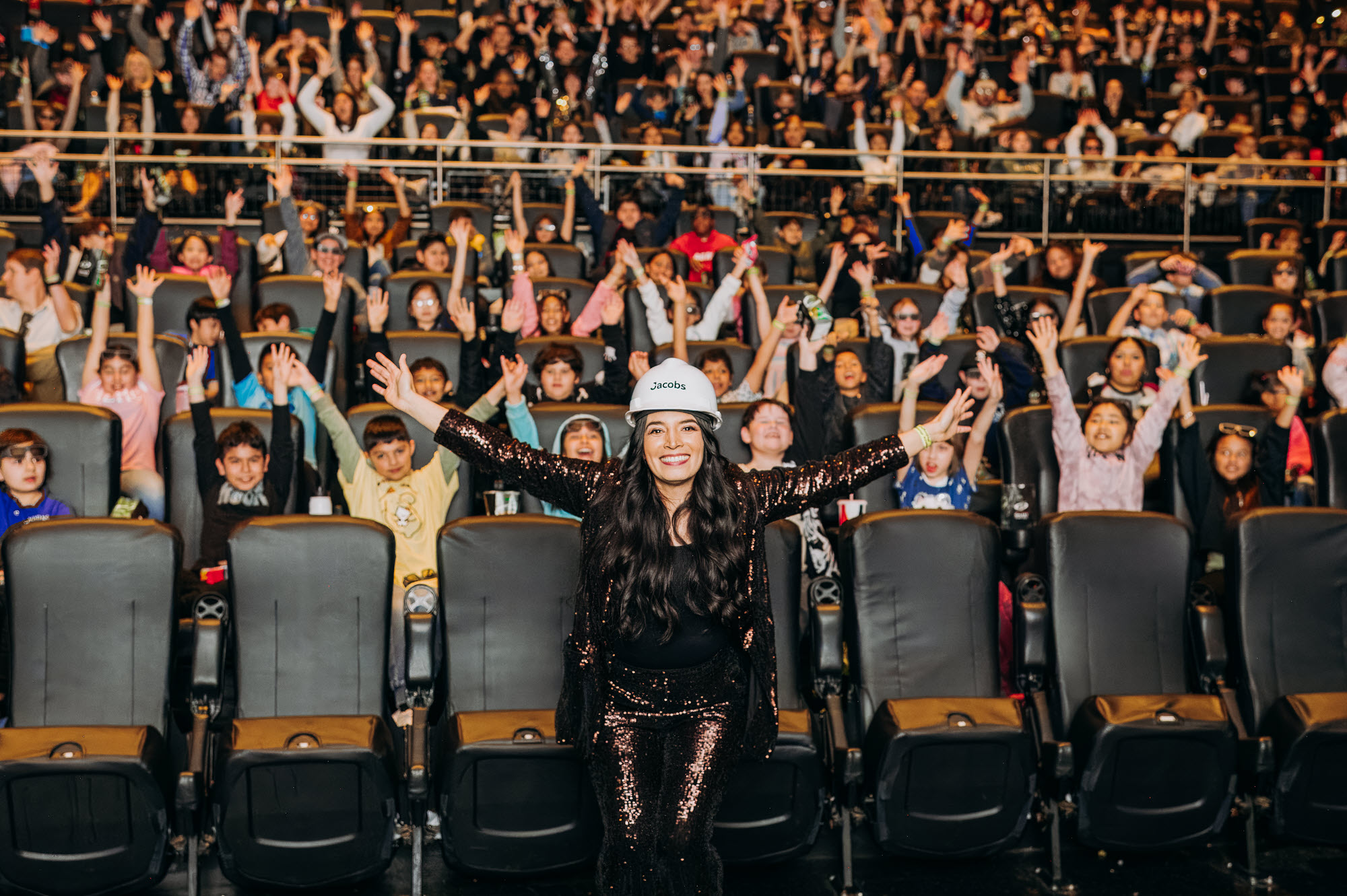 photo of Monica Morales in front of a theater full of students