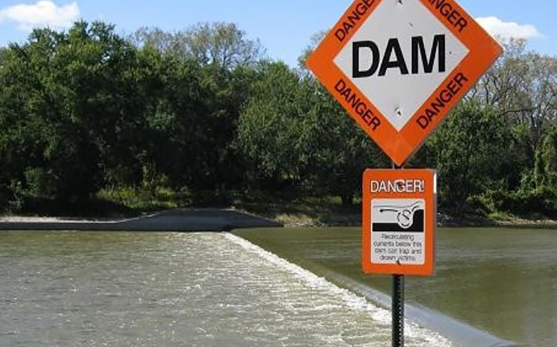 a dam with warning signs