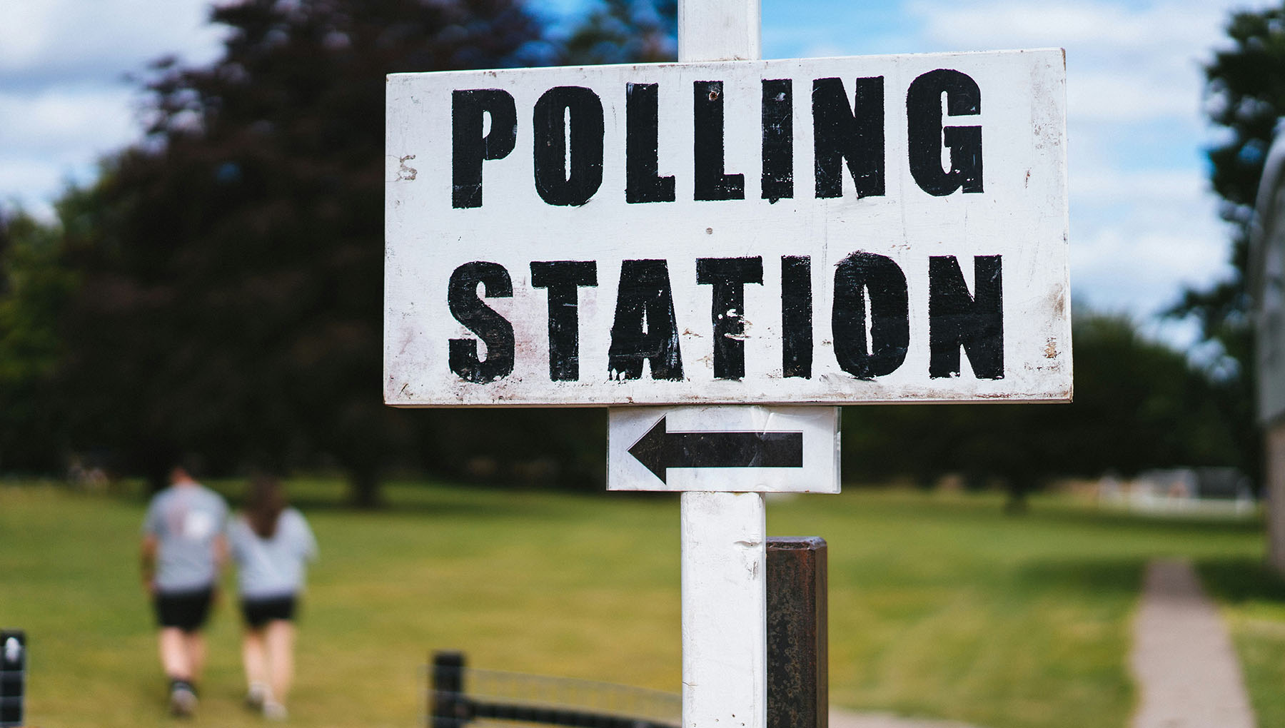 a sign points voters toward the polling place