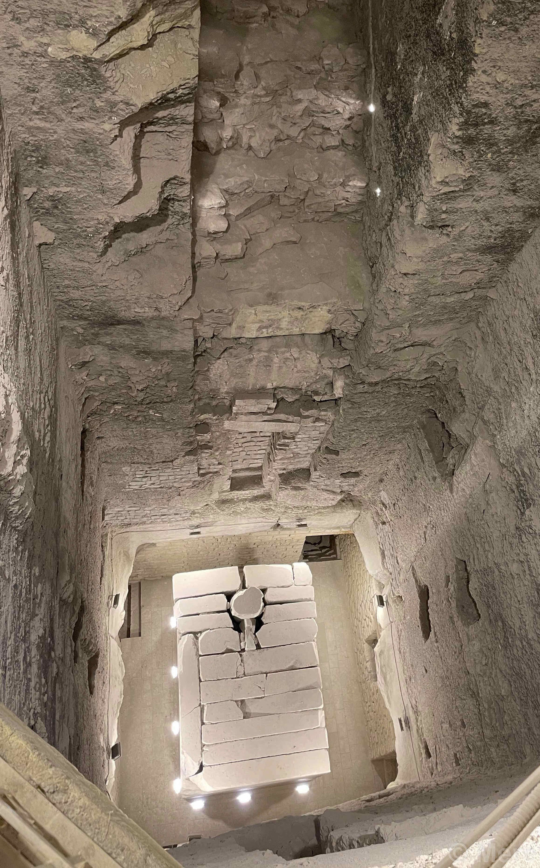 a view down a shaft into a granite chamber inside the pyramid