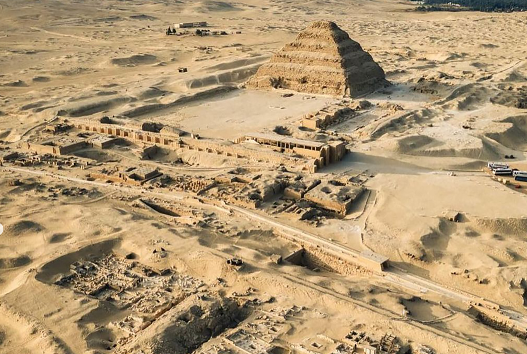 an aerial shot of a pyramid in the desert