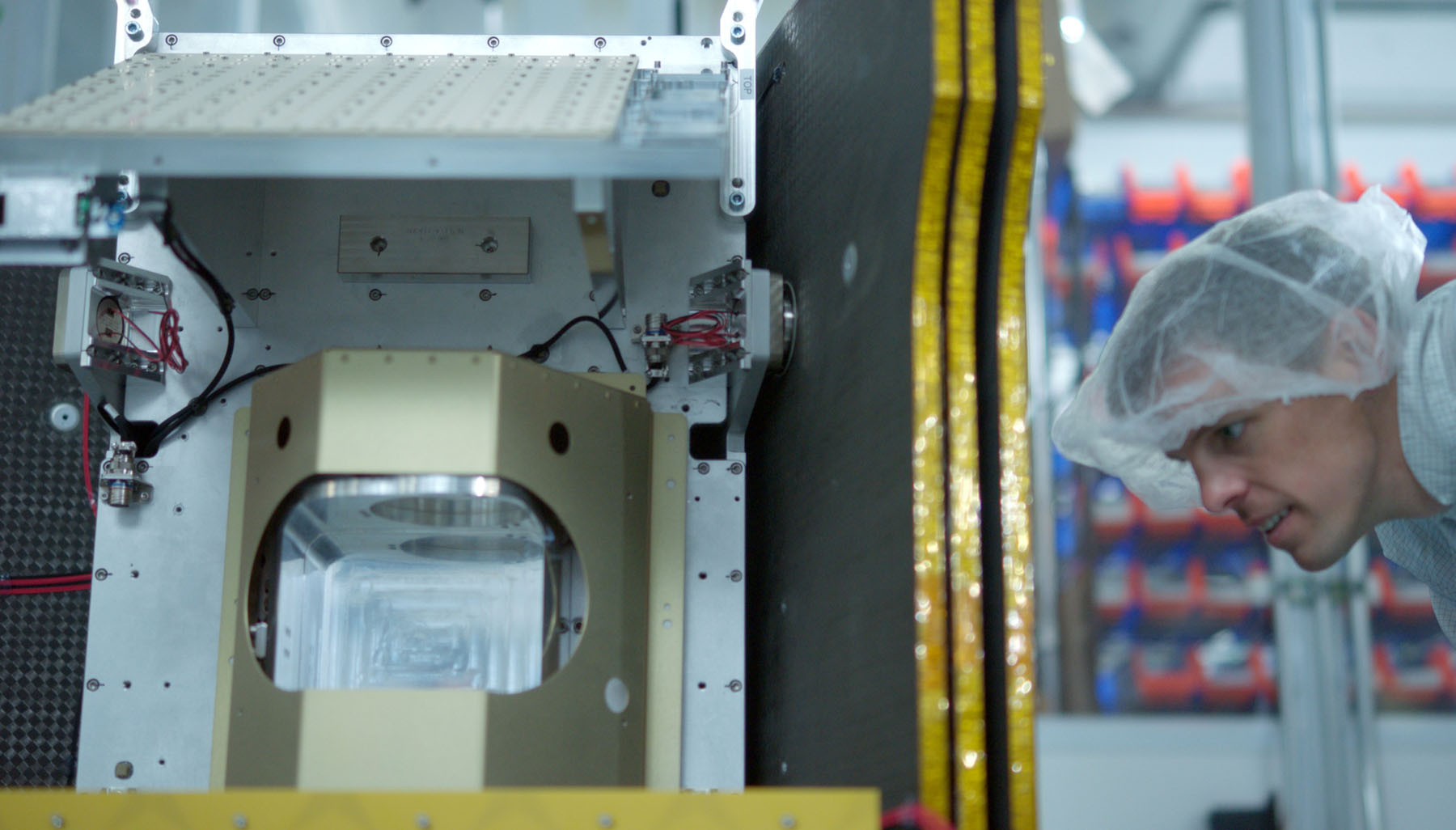 a man works with metal satellite equipment