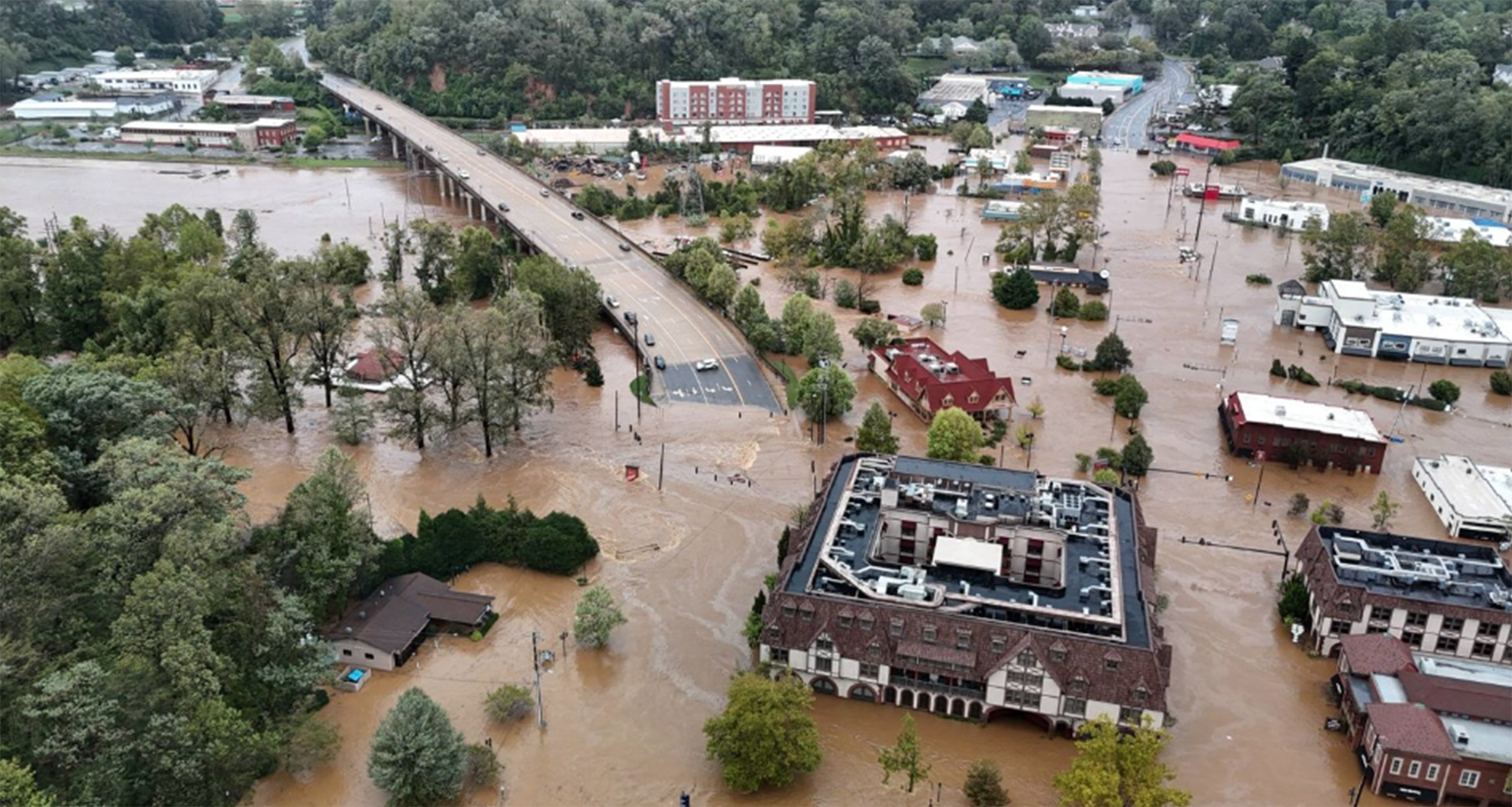 aerial view of a city's streets, buildings and cars inundated by floodwaters