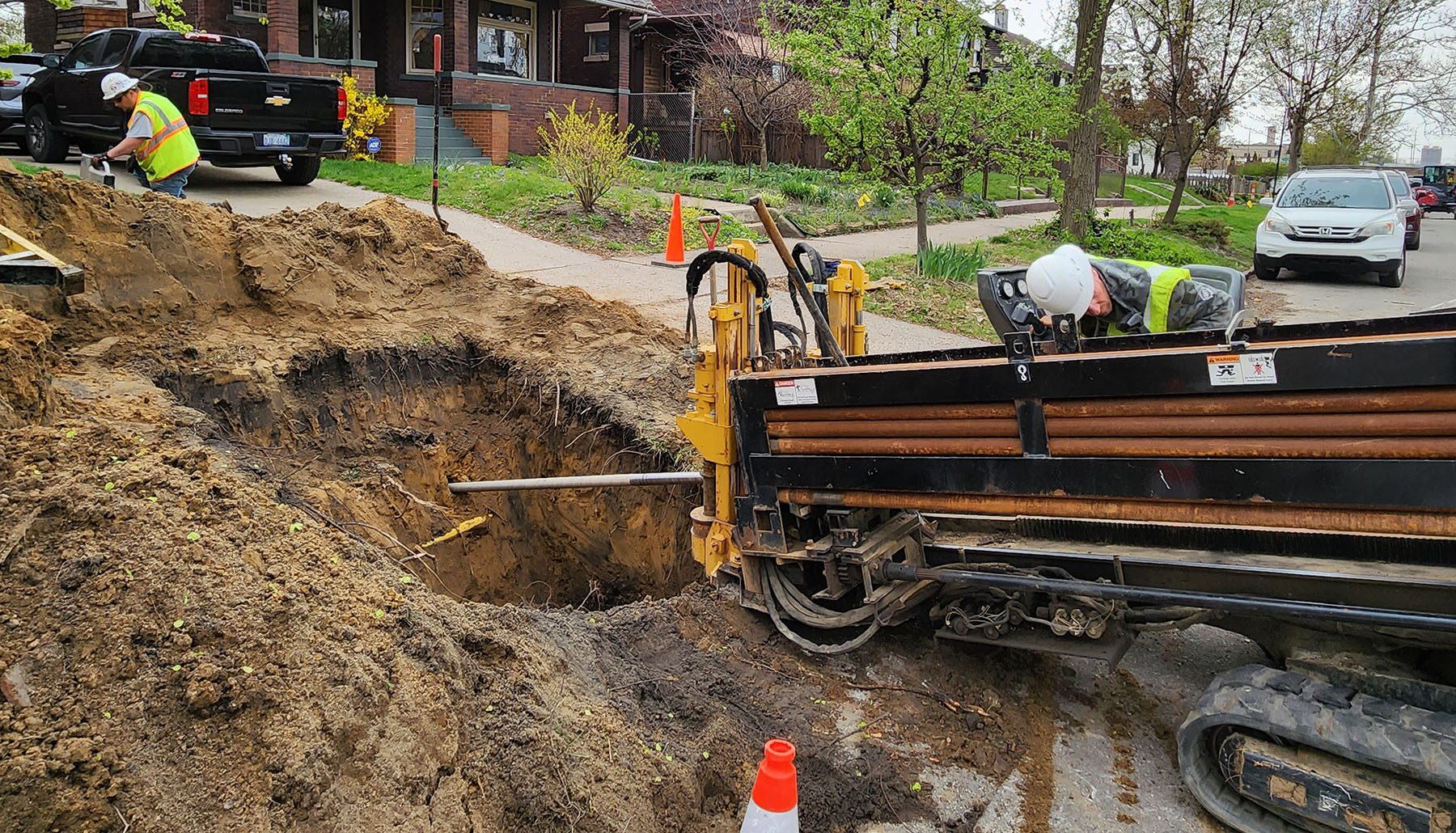 workers and a machine replace service lines