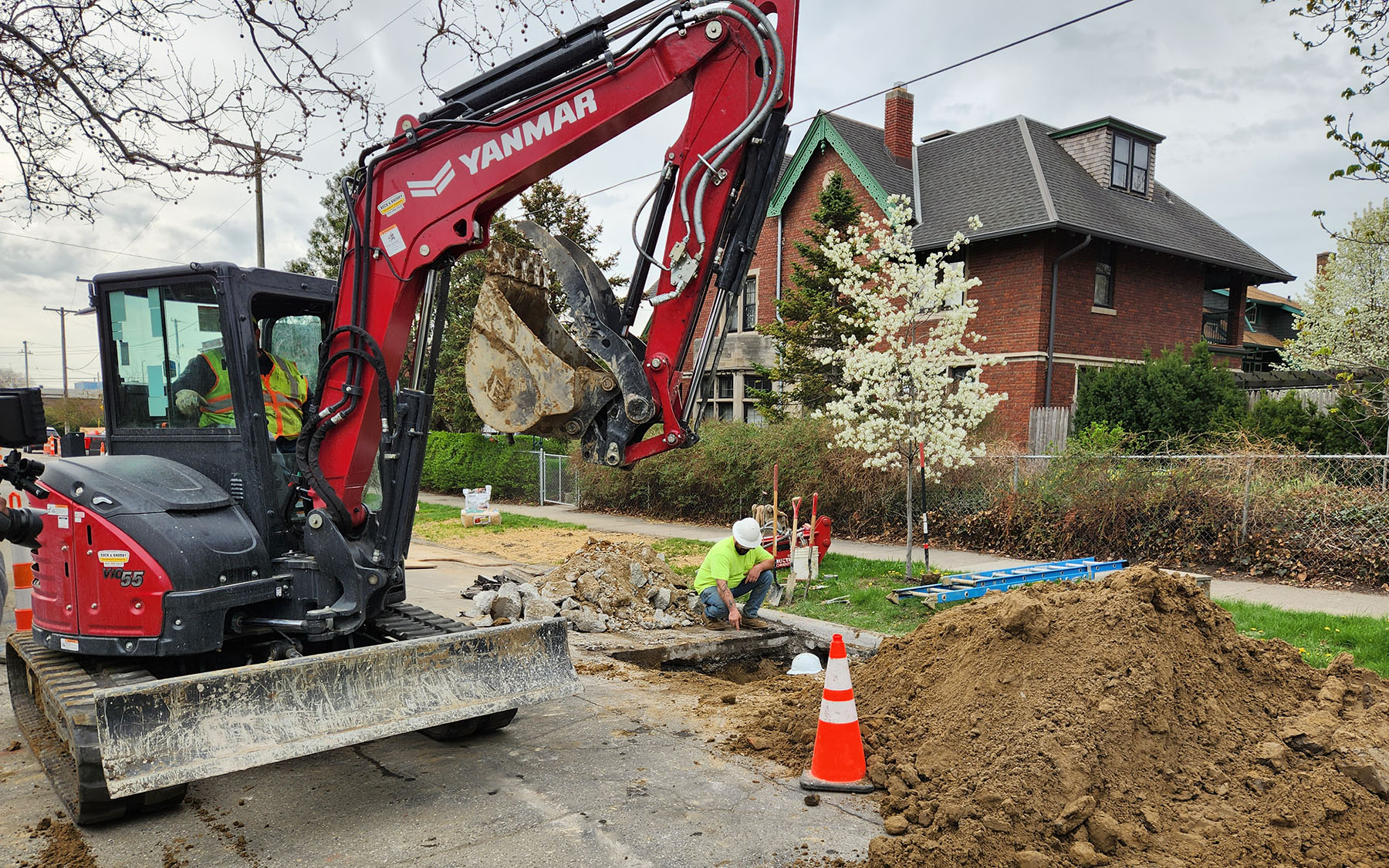 a crane and workers replace utility lines