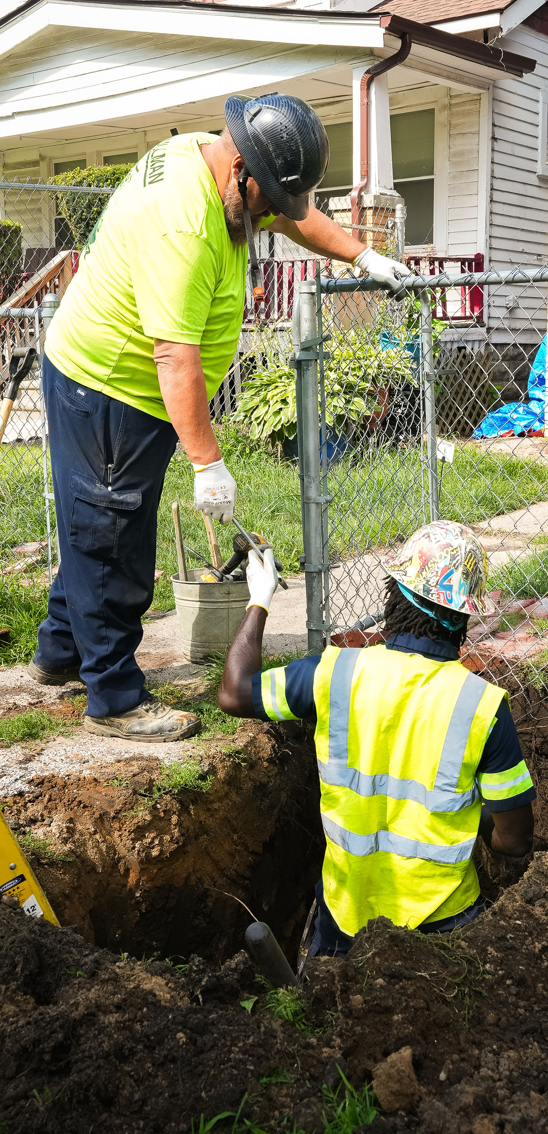 workers replace a service line