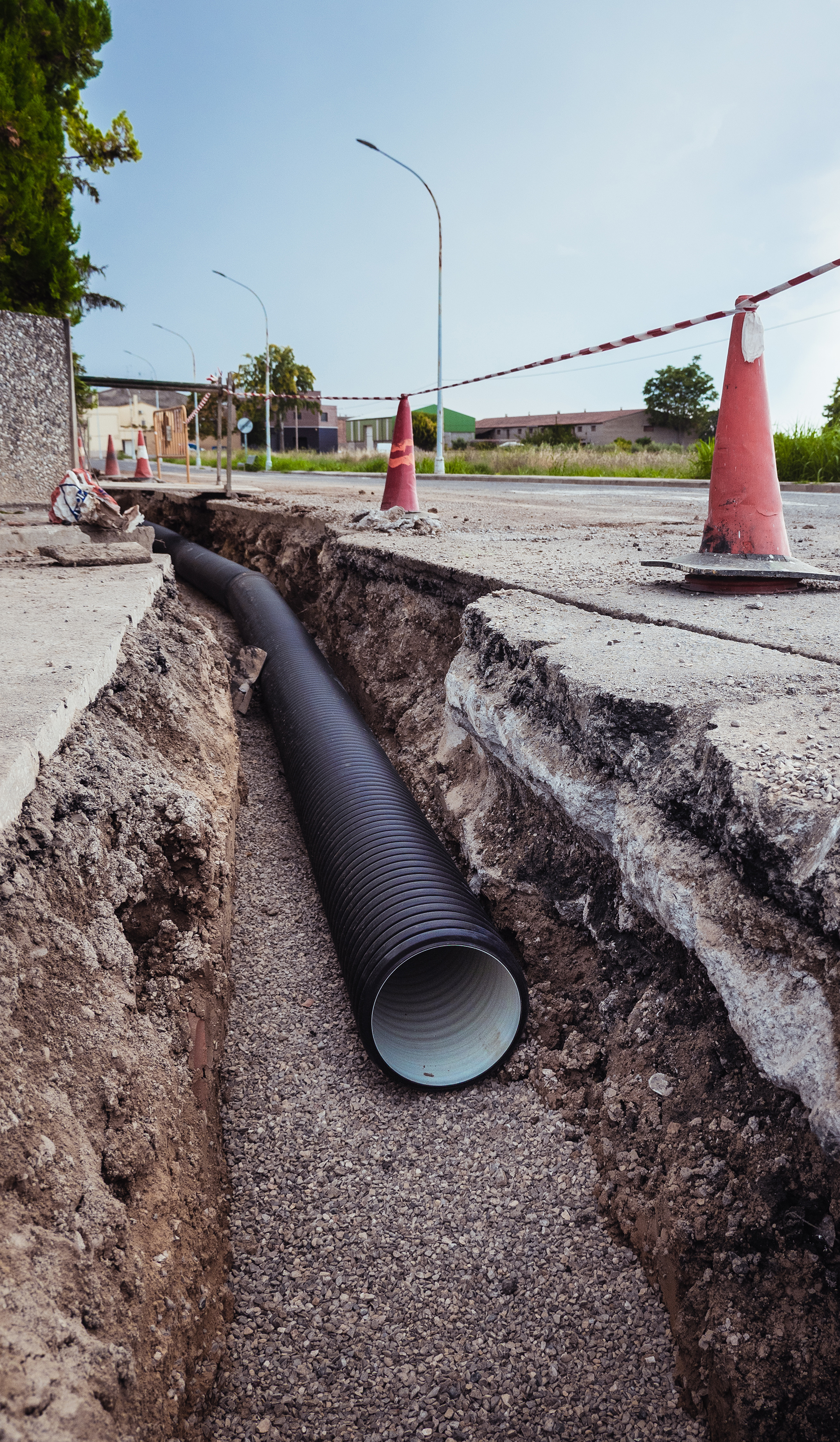 a new water pipe lays in a ditch