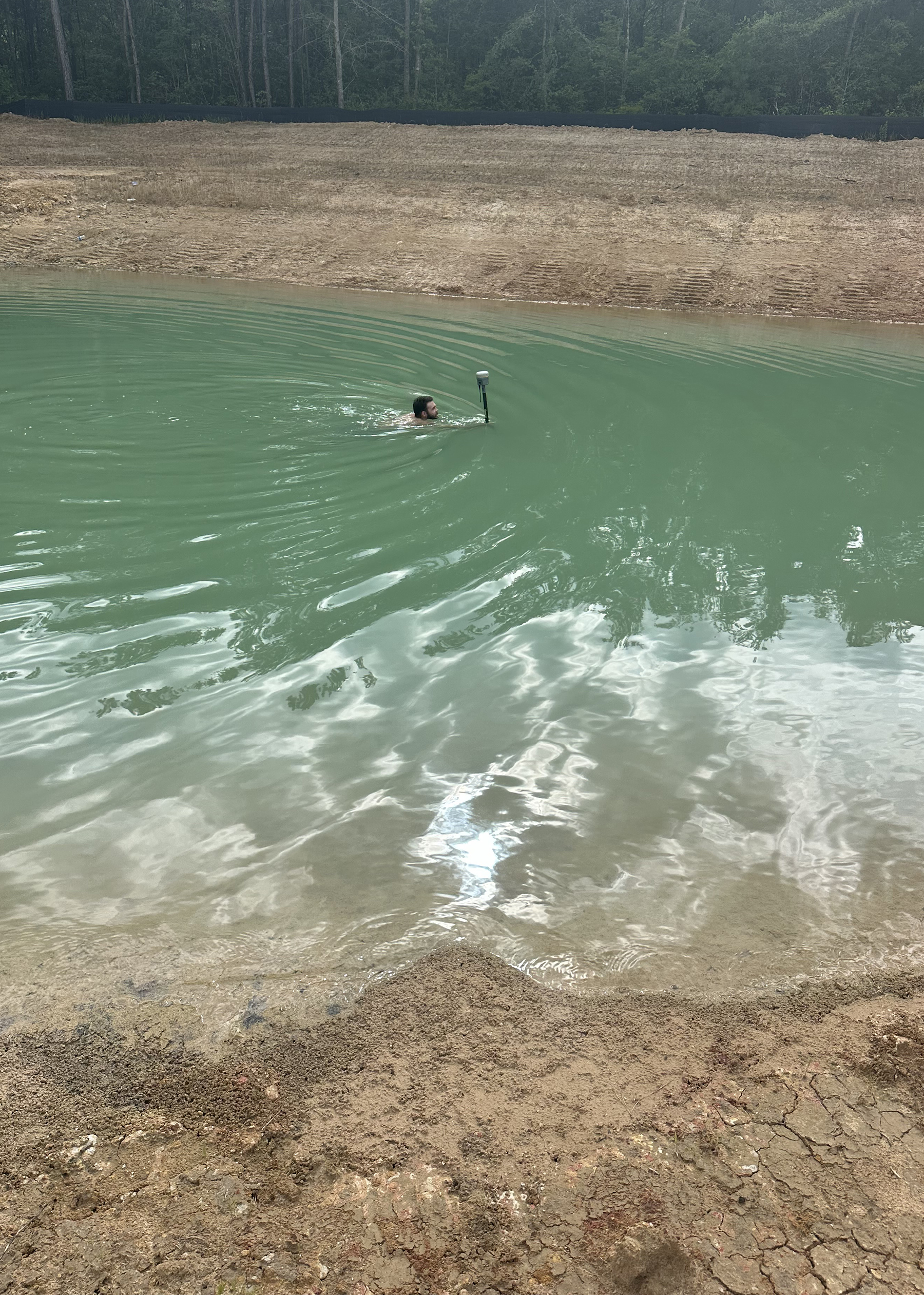 person swims with survey equipment