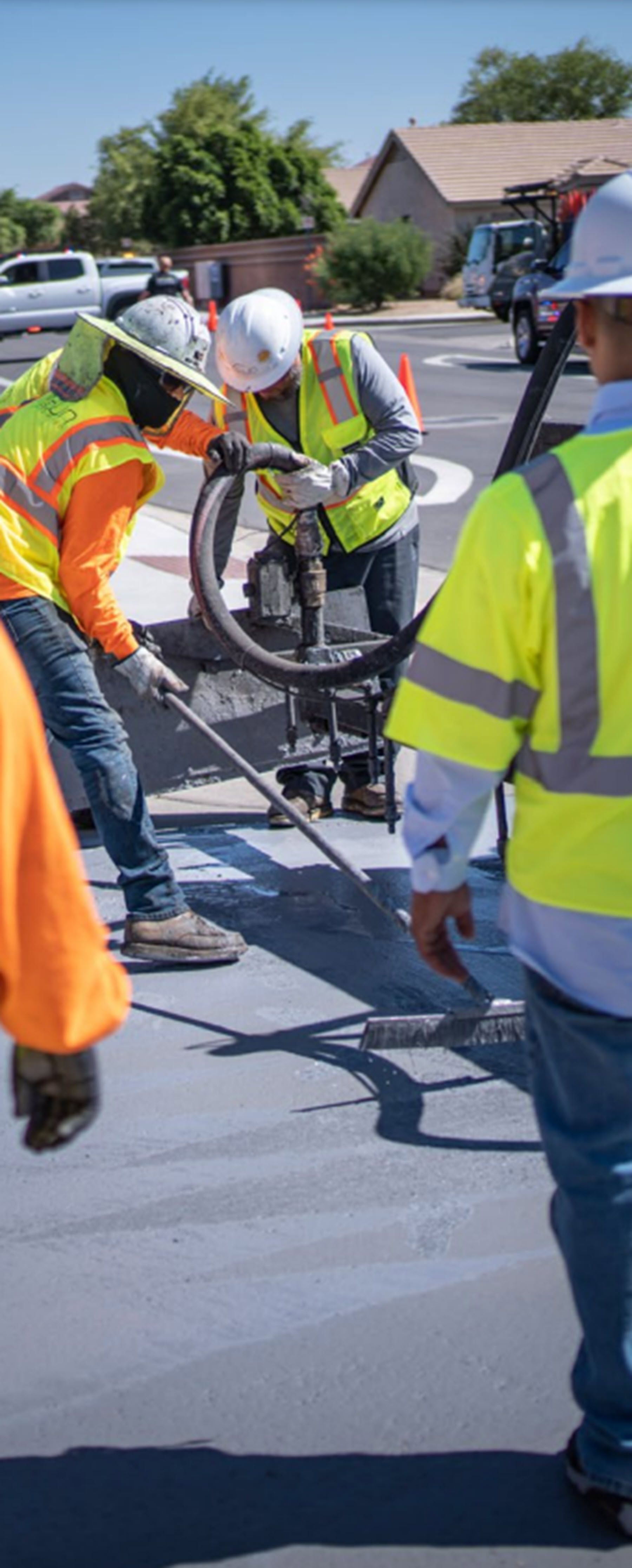 a crew lays cool pavement