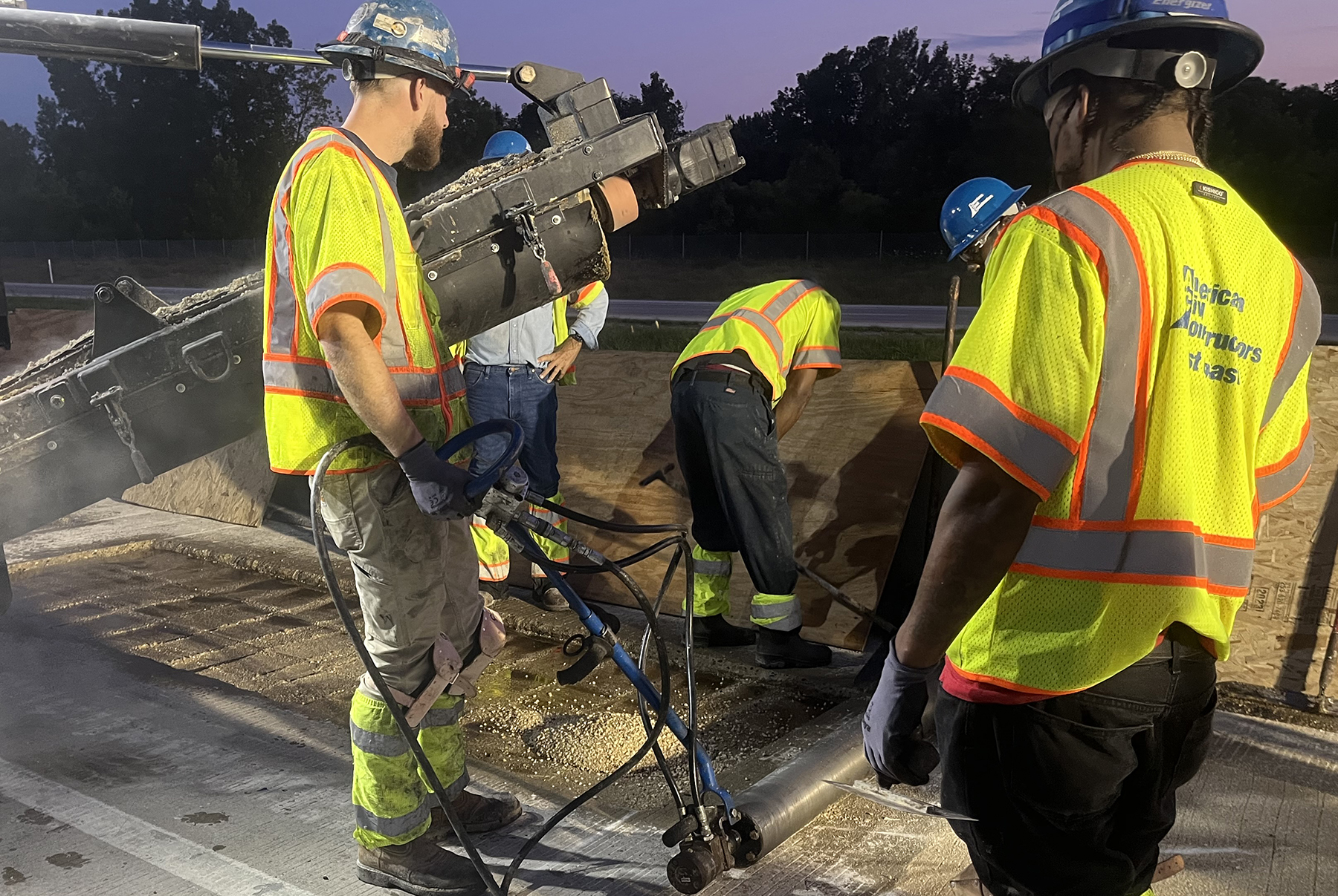 workers pave a road