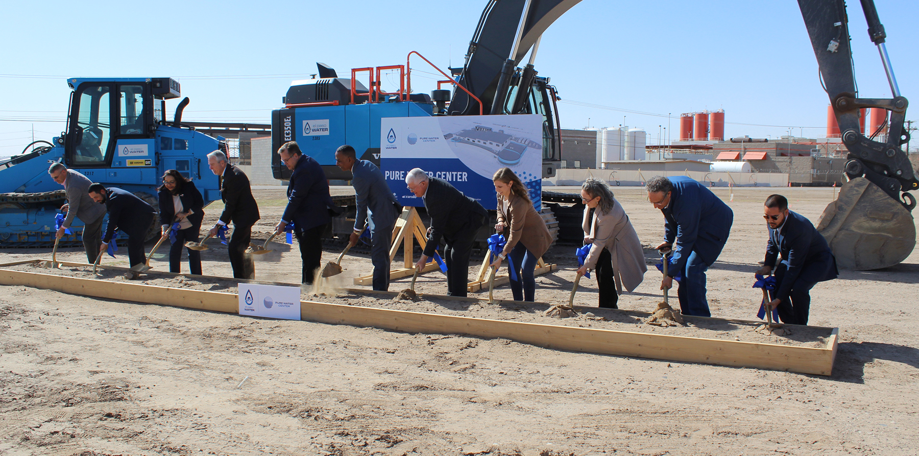 a group of people with shovels dig in at a ceremonial groundbreaking