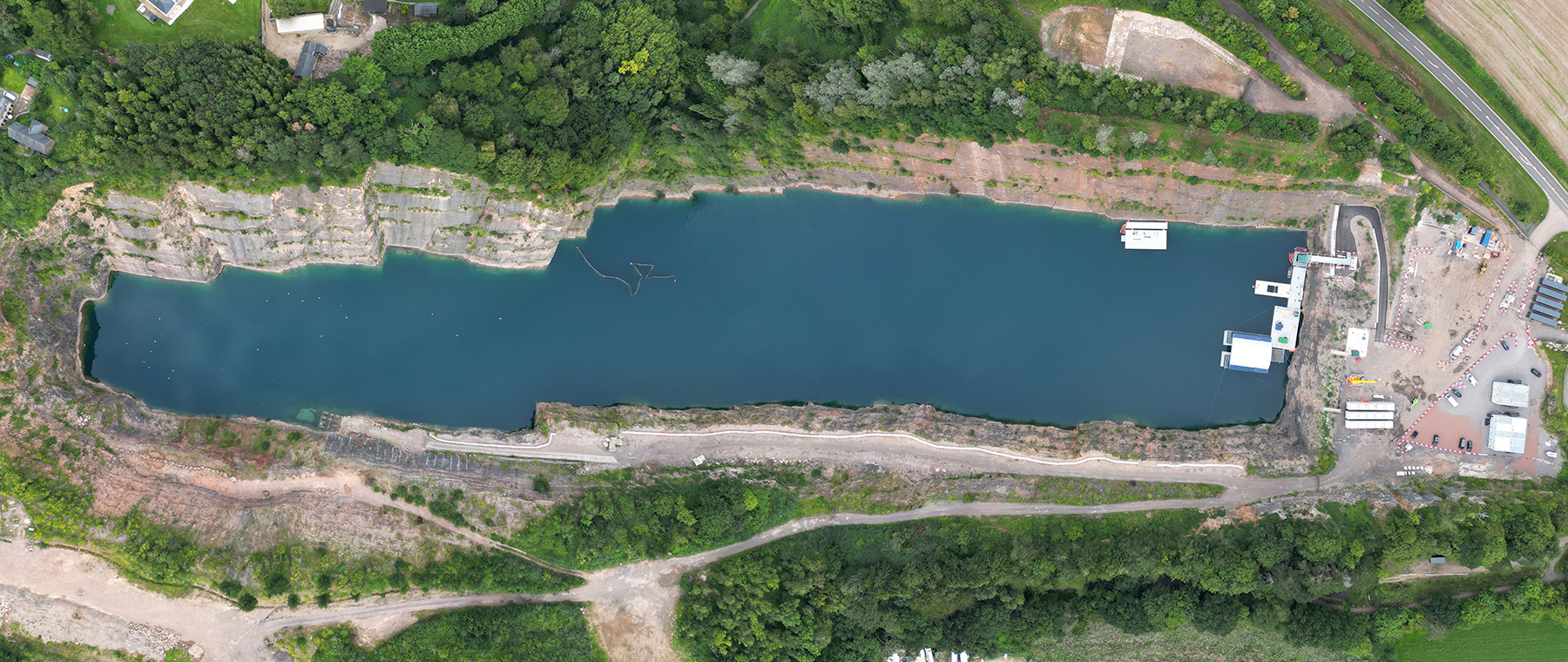aerial view of large water body surrounded by trees and buildings aerial view of large water body surrounded by trees and buildings